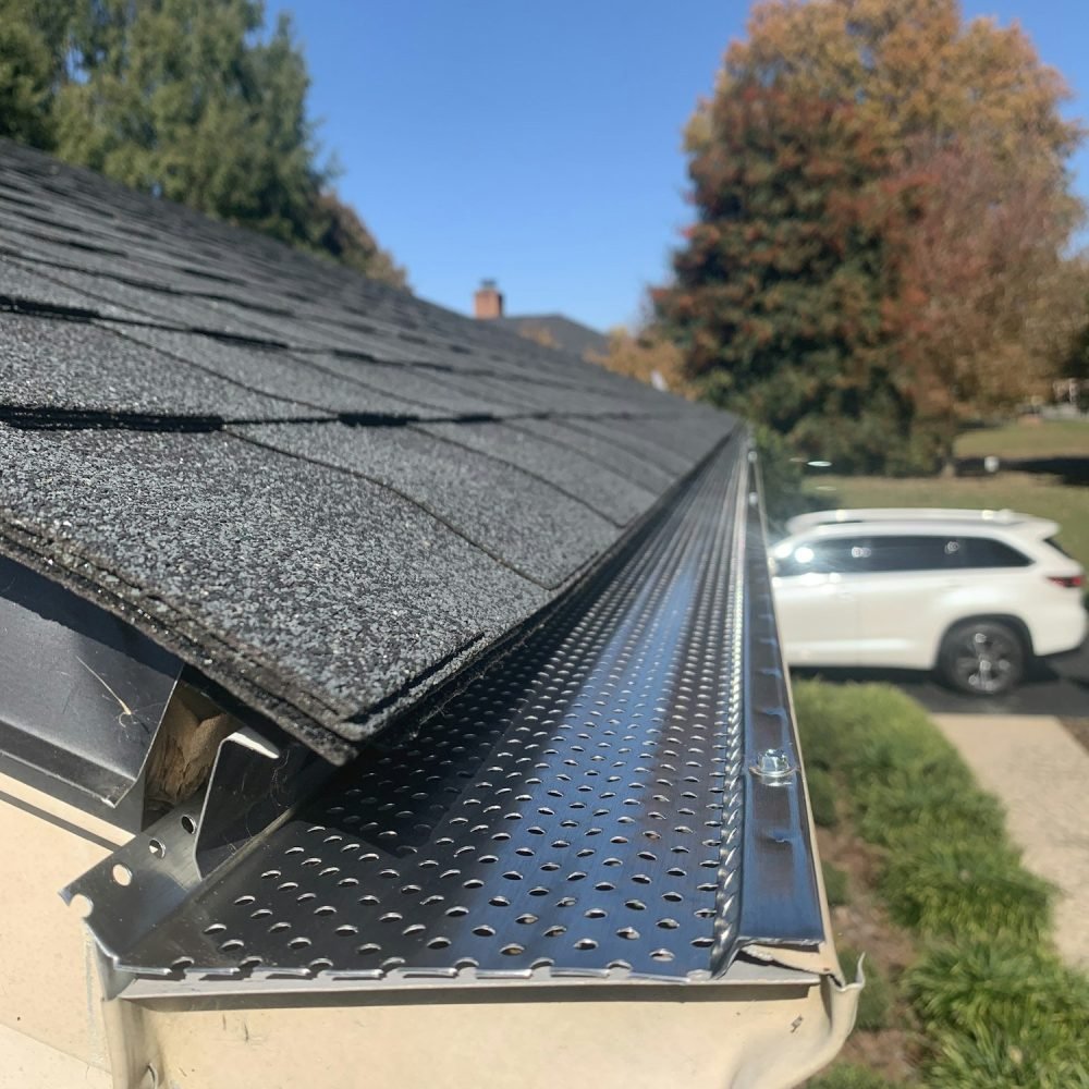 Roof of a house showing gutter and gutter guard protection against leaves